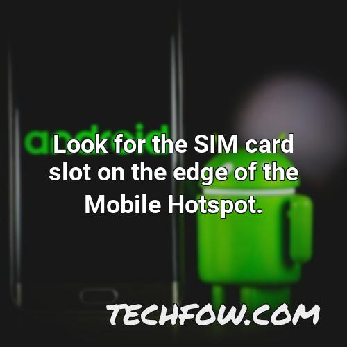 look for the sim card slot on the edge of the mobile hotspot
