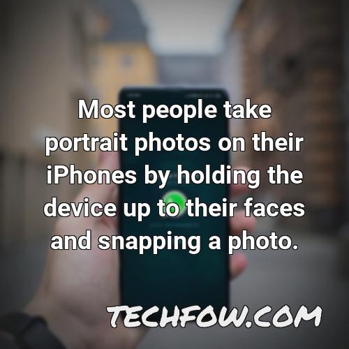 most people take portrait photos on their iphones by holding the device up to their faces and snapping a photo