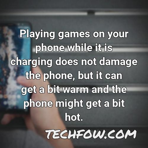 playing games on your phone while it is charging does not damage the phone but it can get a bit warm and the phone might get a bit hot
