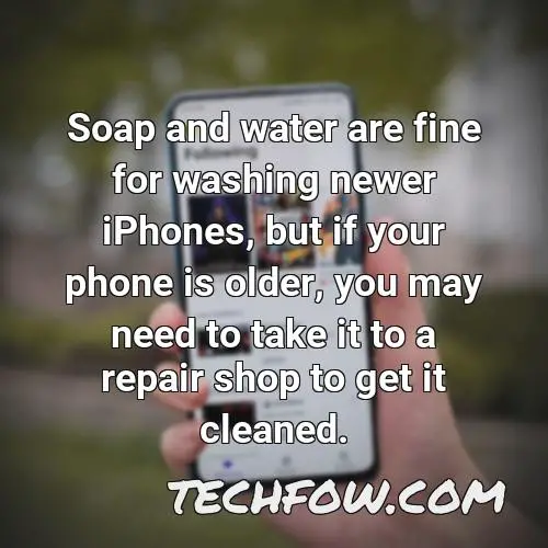 soap and water are fine for washing newer iphones but if your phone is older you may need to take it to a repair shop to get it cleaned