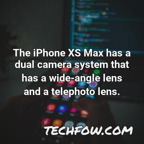 the iphone xs max has a dual camera system that has a wide angle lens and a telephoto lens