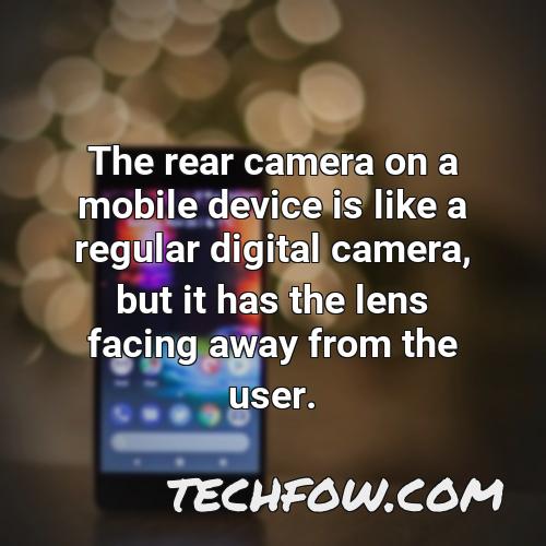 the rear camera on a mobile device is like a regular digital camera but it has the lens facing away from the user