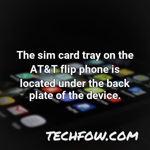 the sim card tray on the at t flip phone is located under the back plate of the device