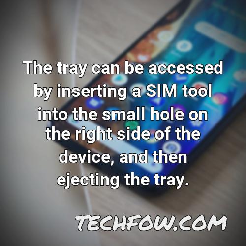 the tray can be accessed by inserting a sim tool into the small hole on the right side of the device and then ejecting the tray