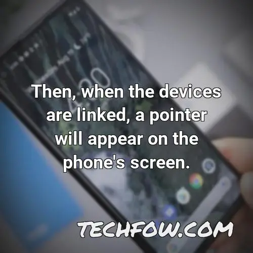 then when the devices are linked a pointer will appear on the phone s screen