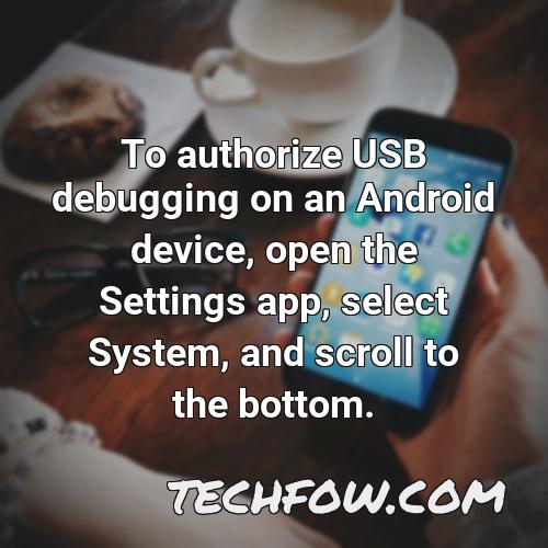 to authorize usb debugging on an android device open the settings app select system and scroll to the bottom