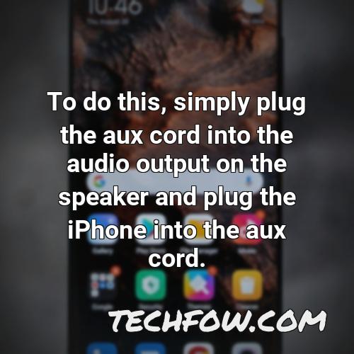 to do this simply plug the aux cord into the audio output on the speaker and plug the iphone into the aux cord