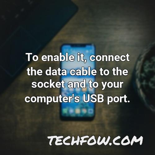 to enable it connect the data cable to the socket and to your computer s usb port