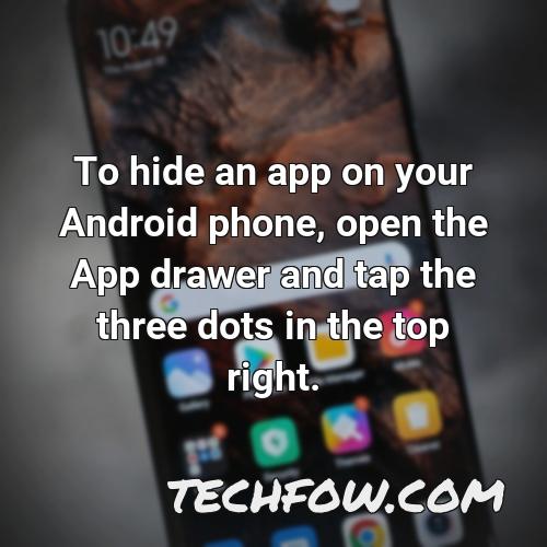 to hide an app on your android phone open the app drawer and tap the three dots in the top right