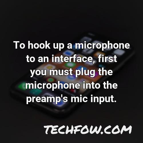 to hook up a microphone to an interface first you must plug the microphone into the preamp s mic input