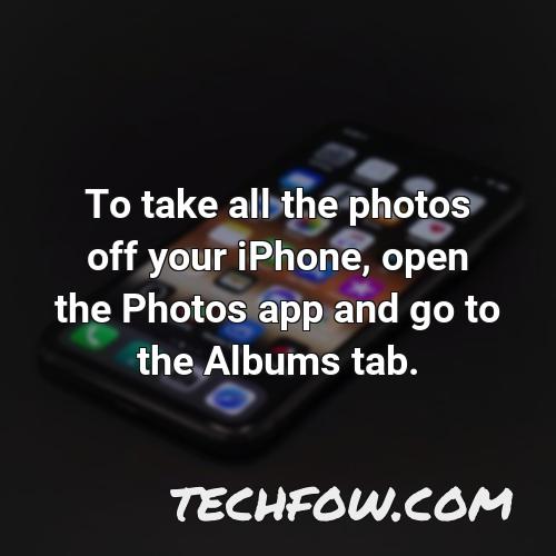 to take all the photos off your iphone open the photos app and go to the albums tab