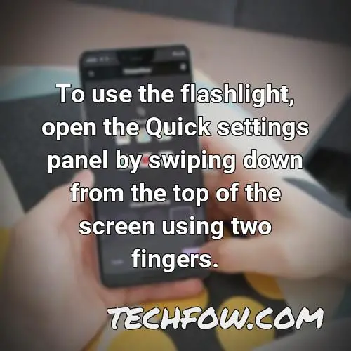 to use the flashlight open the quick settings panel by swiping down from the top of the screen using two fingers