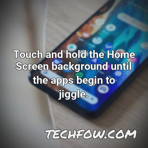 touch and hold the home screen background until the apps begin to jiggle