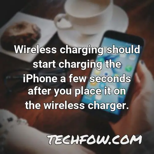 wireless charging should start charging the iphone a few seconds after you place it on the wireless charger
